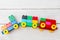 A toy train of cubes of lego on a wooden background. Flat lay