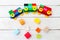 A toy train of cubes of lego and wooden blocks on a wooden background. Educational toys