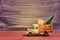 Toy truck carries gifts and a Christmas tree. Photo in vintage style