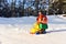 Toy truck with a Christmas ball on background of white snow in forest. Ð¡oncept of preparing for the celebration of New Year.