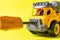 The toy typewriter is a concrete mixer and screwdriver that twists the cog on a yellow background. Photos for a toy store and