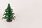 The toy wooden green Christmas tree with little toys on white background