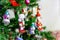 A toy wooden nutcracker hangs on a Christmas tree as a decoration