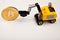 Toy yellow excavator bitcoin coin white background