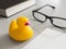 Toy yellow rubber duck on the desktop. Opposition symbol and political struggle