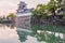 Toyama castle with beautiful sunset and reflection in water.