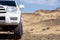 Toyota 4runner SUV in desert canyon with blue sky. 4wd SUV car road canyon desert. Outdoor landscape. Travel in Kazakhstan concep