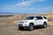 Toyota 4runner SUV in desert road with blue sky. 4wd SUV car road canyon desert. Outdoor landscape. Travel in Kazakhstan concept.