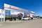 Toyota dealership with a modern facade and cars on display in front of the retail center