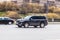 Toyota Land Cruiser 200 rides on the city highway. Black premium SUV on the city street in motion