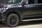 The Toyota Land Cruiser car covered with a protective paint and varnish matte film of black color is in the repair shop. PPF