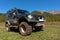 Toyota Land Cruiser Prado - extreme off-road expedition car on mountain forest landscape