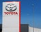 Toyota logo in the dealership of the area, against blue sky.  It is the symbol of the   japanese vehicle manufacturer