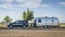 Toyota Sequoia SUV with Aistream Trade Wind travel trailer at parking lot