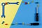 Toys background. Kids construction toys tools frame on blue and yellow background. Top view