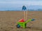 Toys on the beach plastic wheelbarrow, bucket and spade