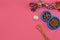 Toys -multi coloured rope, ball, dry food and bone. Accessories for play on pink background top view