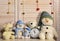 Toys placed on chest of drawers on wooden wall background