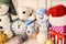 Toys placed on wooden wall background. Snowmen and teddy bears