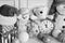 Toys placed on wooden wall background. Snowmen and teddy bears
