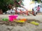 Toys for sand digging it have a beautiful color Lay on the sand. the background is a playground. have a children and adults