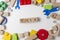 Toys word written in wooden cubes. Children toy on white background as frame with copy space for text. Top view