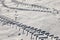 Trace of a car or tractor in the freshly fallen snow. Abstract illustration photo of hard weather traffic conditions.