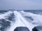 Trace tail of ferry speed boat on surface sea water. White wave view behind speed boat. Travel concept