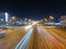 traces of headlights of cars at night on the avenue, shot with a long exposure