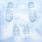 Traces of men`s shoes and women`s boots in the snow. Clear deep footprints on white winter snow. Track in snow. Overhead