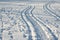 traces of a snowmobile and human footprints in the snow, trails