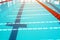 Track & lanes of a competition swimming pool..Indoor swimming pool with empty lanes..Olympic standard swimming pool &  diving pool