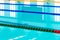 Track & lanes of a competition swimming pool..Indoor swimming pool with empty lanes..Olympic standard swimming pool &  diving pool