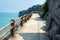 Track looking at calm blue seaside and rocks