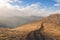 Track in the mountains in the fall, rocks, forest and sky