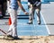 Track officials measuring the jumps in the sand pit