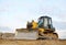 Track-type bulldozer, earth-moving equipment. Land clearing, grading, pool excavation, utility trenching, utility trenching and