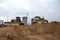 Track-type bulldozers with bucket for pool excavation and utility trenching. Dozer during land clearing and foundation digging.