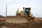 Track-type dozer for pool excavation and utility trenching. Bulldozer during land clearing and foundation digging. Earth-moving