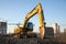 Track-type excavator during earthmoving at construction site. Backhoe digging the ground for the foundation