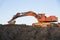Track-type excavator during earthmoving work at open-pit mining. Loader machine with bucket in sand quarry