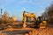 Tracked excavator with a bucket in the ground at a construction site