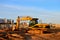 Tracked excavator with a bucket in the ground at a construction site