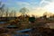 Tracked excavator with a bucket in the ground at a construction site during the laying of sewer pipes in the ground