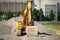 Tracked excavator on a construction site among piles of crushed stone