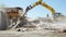 Tracked excavator demolishing old buildings