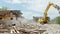 Tracked excavator demolishing old buildings, time lapse