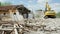 Tracked excavator demolishing old buildings, time lapse