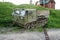 tracked tractor. old military crawler tractor all-terrain vehicle near dirt road on background of green grass