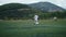 Tracking camera of a little boy scoring a goal in football field